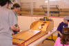 Skee ball traditional carnival fun game invites everyone to roll the ball up the ramp and get the ball into the holes.